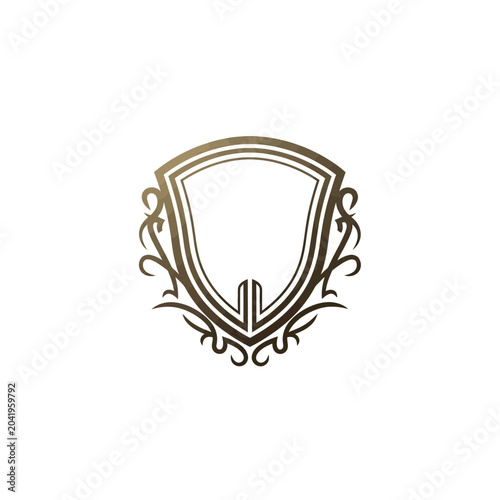 Elegant ornate shield logo with symmetrical scrollwork, a luxurious classic vector emblem symbolizing protection, heritage, and distinction for premium brands