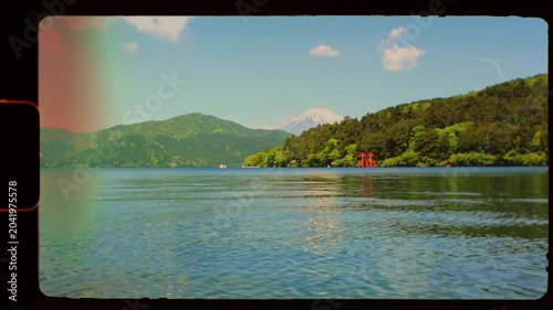 Lake view in Hakone, Japan with shrine Mount Fuji in background on beautiful sunny day, vintage retro 8mm film negative