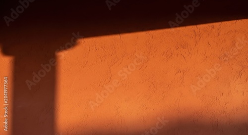 Warm Terracotta Polished Plaster Wall Surface with Textured Finish and Contrasting Shadow