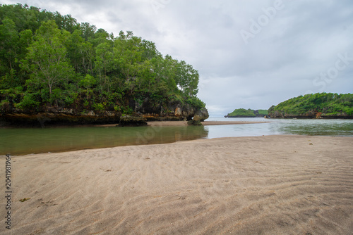 Tropical Lagoon and Sandy Beach with Rocky Cliffs in Indonesia