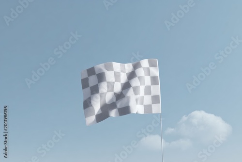 A checkered flag flying high in the sky with a pole firmly planted in the ground. the flag is alternating white and grey squares and the sky is a bright blue with white clouds scattered throughout.