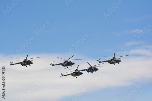 Military helicopter in the sky. Flying helicopters