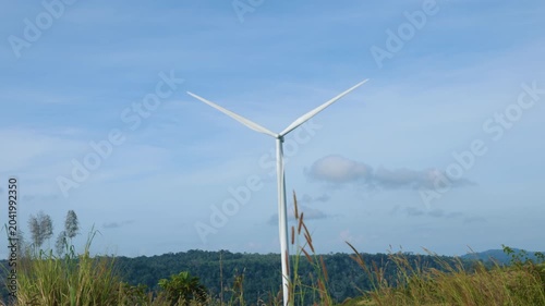 Aerial view of powerful Wind turbine farm for energy production on beautiful cloudy sky at highland. Wind power turbines generating clean renewable energy for sustainable development green energy. 