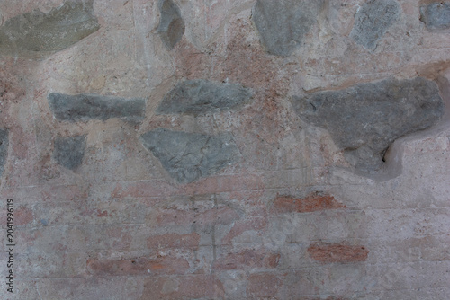 Canvastavla This image displays a weathered wall texture featuring rough grey stones and old