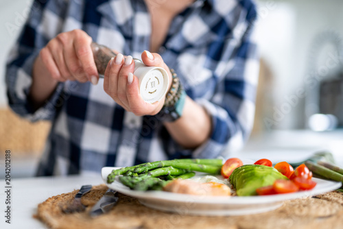 Girl Sprinkles Pepper On Breakfast Egg Fish Asparagus And Cherry Tomatoes Healthy Eating