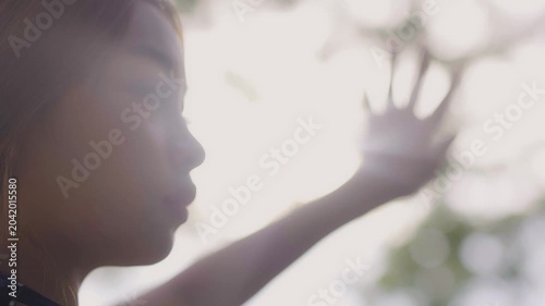 The woman looked at the sun through her hands.