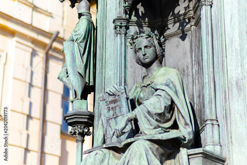 Slika na platnu Detailed close-up of the allegorical Neo-Gothic bronze statue representing the Faculty of Law on the Charles IV Monument, Prague
