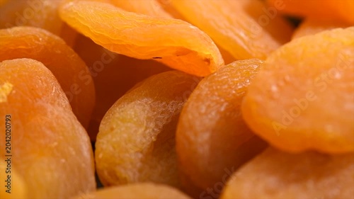 Dried apricots background close-up. Apricot fruits. Ripe Organic Apricots fruit rotating backdrop. Close up. Heap of dried apricot background, vegan food, top view 