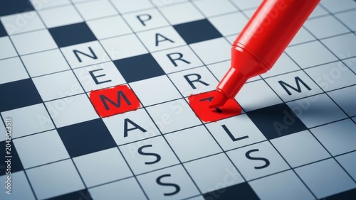 Close-up of a red marker filling in a crossword puzzle, highlighting letters M, A, R, and T on a white grid with dark blue squares.