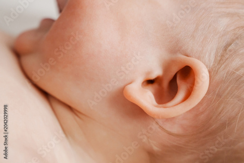 Macro detail of a small cute baby ear and soft textur skin