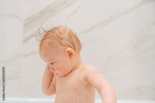 Cute Baby Touching Wet Hair During Bath Time