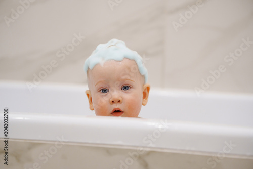 Happy Baby Bathing Routine in a Modern White Bathtub