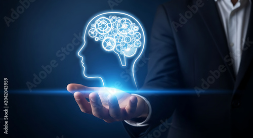 Human hand holding glowing digital brain hologram with futuristic technology interface in dark background