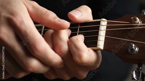 Musician Playing Acoustic Guitar Close Up on Fretboard.