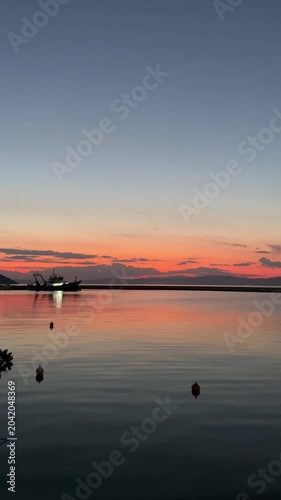 Stunning sunset over the ocean with a vibrant orange sky and deep blue sea