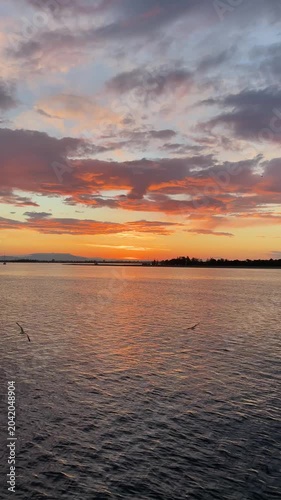Stunning sunset over the ocean with a vibrant orange sky and deep blue sea