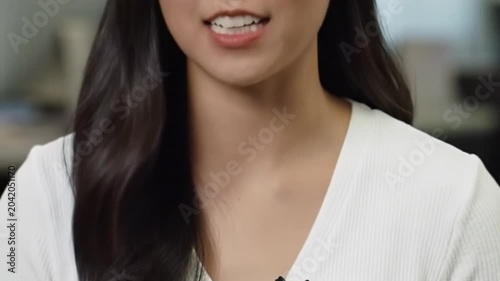 Close up shot of a young professional woman speaking.