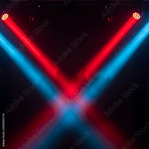 Vibrant Red and Blue Stage Light Beams Crossing in Dark Concert Venue