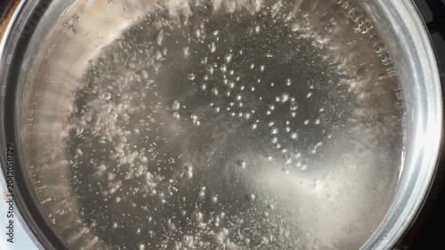 Water in stainless steel pot during the boiling close-up
