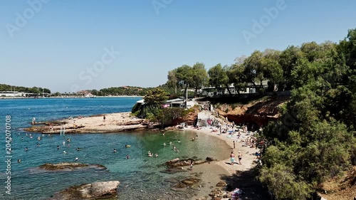 Crystal Clear Waters of Vouliagmeni Lake Beach with Swimmers.