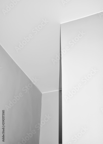 Clean white wall corner with sharp geometric lines, minimalist architectural detail, abstract composition with shadows, modern interior or exterior design element, simple empty space