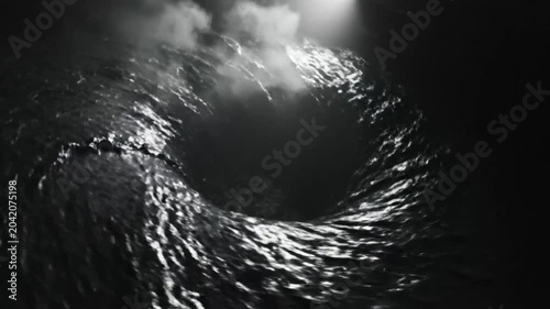 Black and white view of a water vortex drawing everything towards the dark center with light peaking through