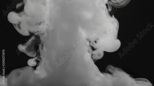 Abstract white smoke slowly rising on a dark background, creating organic shapes and patterns