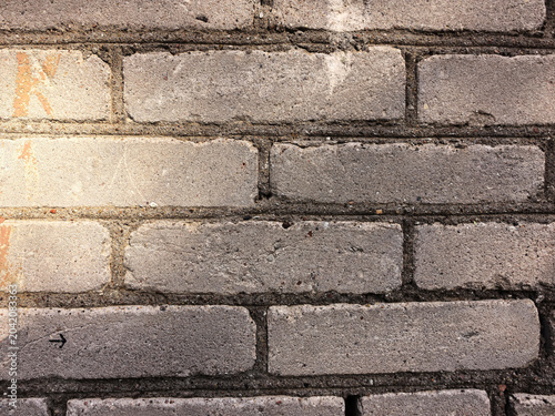 Sun ray on old white brick wall. Slightly scuffed weathered surface