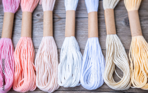 Tableau sur toile Colorful embroidery floss skeins in vibrant rainbow hues, cascade multicolored f