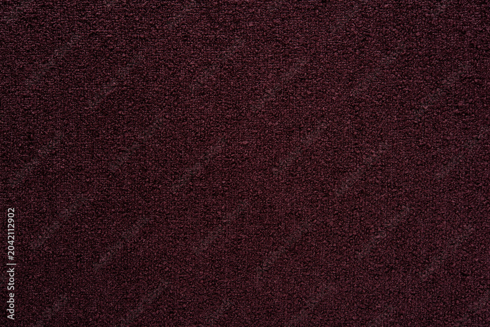 Fototapeta premium Dark burgundy bouclé fabric texture background, maroon textured cloth with grainy pattern.