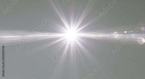 Bright, starburst-like light flares emanate from a central point across a muted background