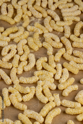 Fotografija yellow sticks of corn flour with added sugar for quick cooking with milk or yogu