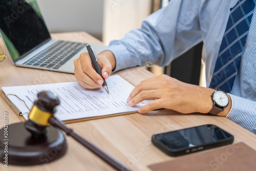 Signing legal documents in an office setting business environment professional work close-up view for compliance purposes
