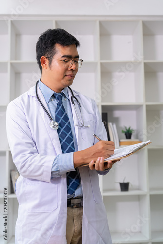 Healthcare professional writing notes medical office photograph indoor setting close-up perspective patient care insights