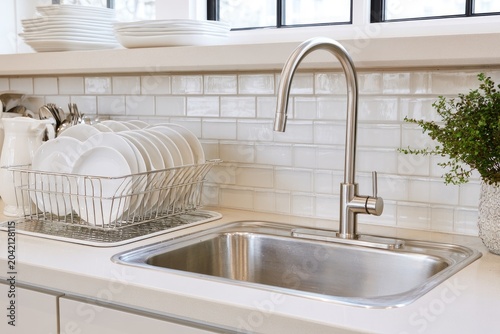 Stainless steel sink and faucet with drying rack of dishes