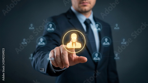 Businessman touching a glowing employee icon on a virtual screen, representing recruitment, hiring, and human resources