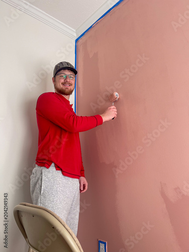 Man painting interior wall during home renovation