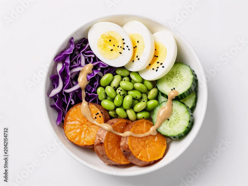 Top view of a nutritious salad bowl with sliced eggs cucumbers and sesame seeds