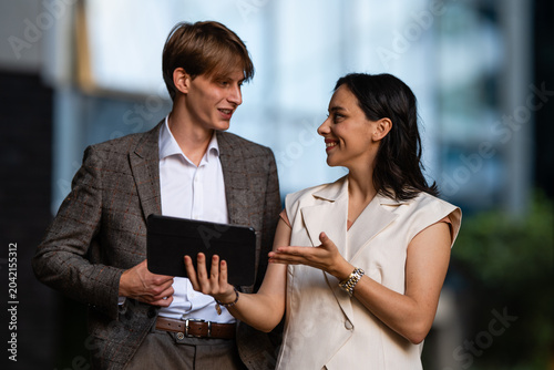 фотографія Business people collaborating on a tablet outdoors