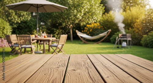 Outdoor garden setting with wooden table, hammock, barbecue grill, and dining area under an umbrella surrounded by lush greenery