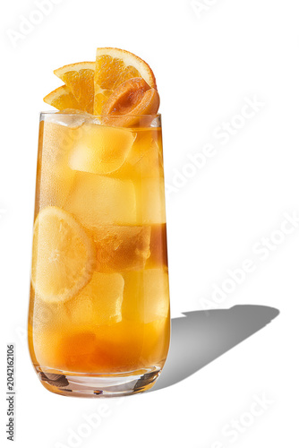 Eye level shot of refreshing iced apricot orange fruit tea with citrus slices and ice cubes, isolated.