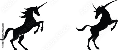 Bild auf Leinwand Rearing unicorn silhouette pair featuring magical horse with spiraled horn and flowing mane for fantasy fairytale theme