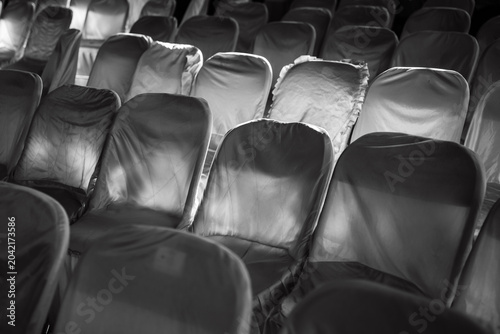 Rows of neat, patterned white chairs covered in clean cloth