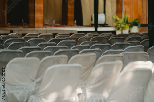 Rows of neat, patterned white chairs covered in clean cloth