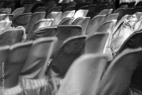 Rows of neat, patterned white chairs covered in clean cloth
