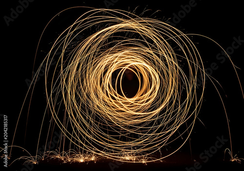 Circular light painting with sparks, slow shutter speed, abstract pattern, isolated on transparent background, dark, glowing, energetic, creative