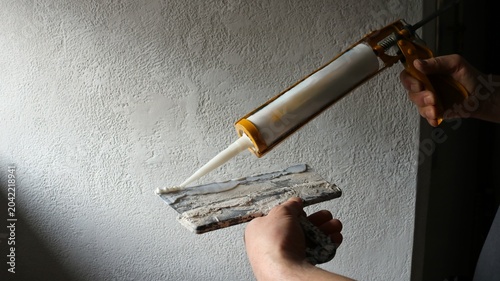Bild auf Leinwand The process of applying mortar or sealant during renovation work