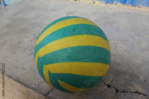 plastic ball, Green and yellow patterned plastic balls on the cement floor, children's toys