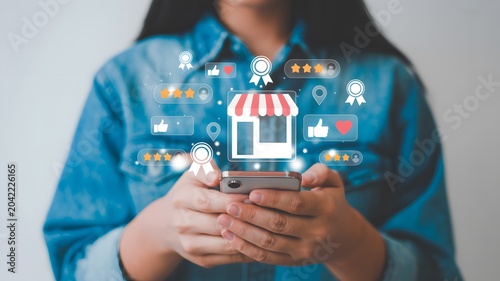 Online shopping and e-commerce concept with a person holding a smartphone displaying a storefront and shopping icons