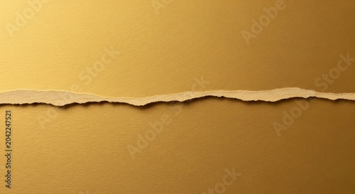 Torn golden paper strip with textured edges and subtle lighting